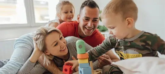 family with young children playing