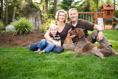 Smiling family and dog