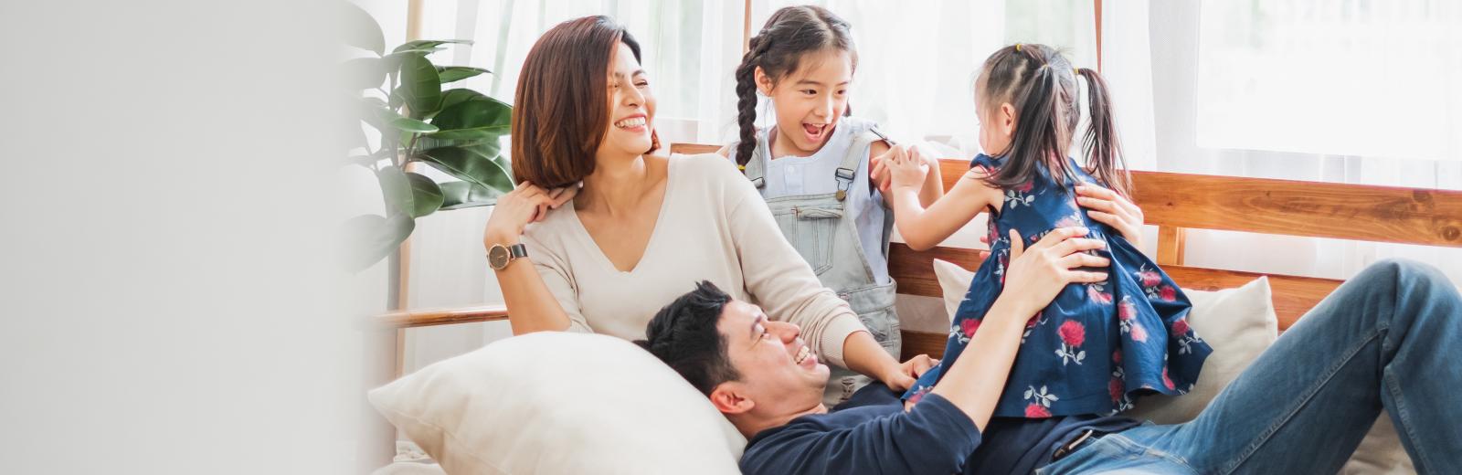 Family sitting on the couch together.