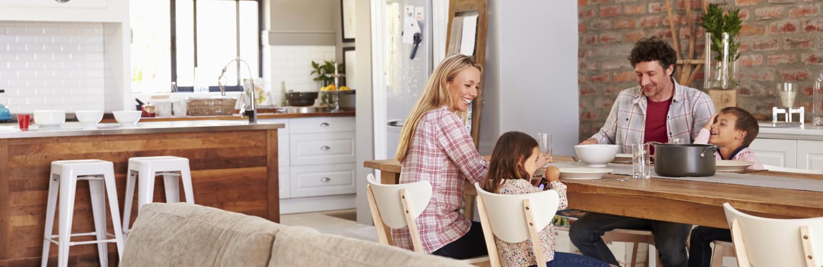 Family sitting at the dining room table together.