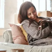 woman with dog on couch