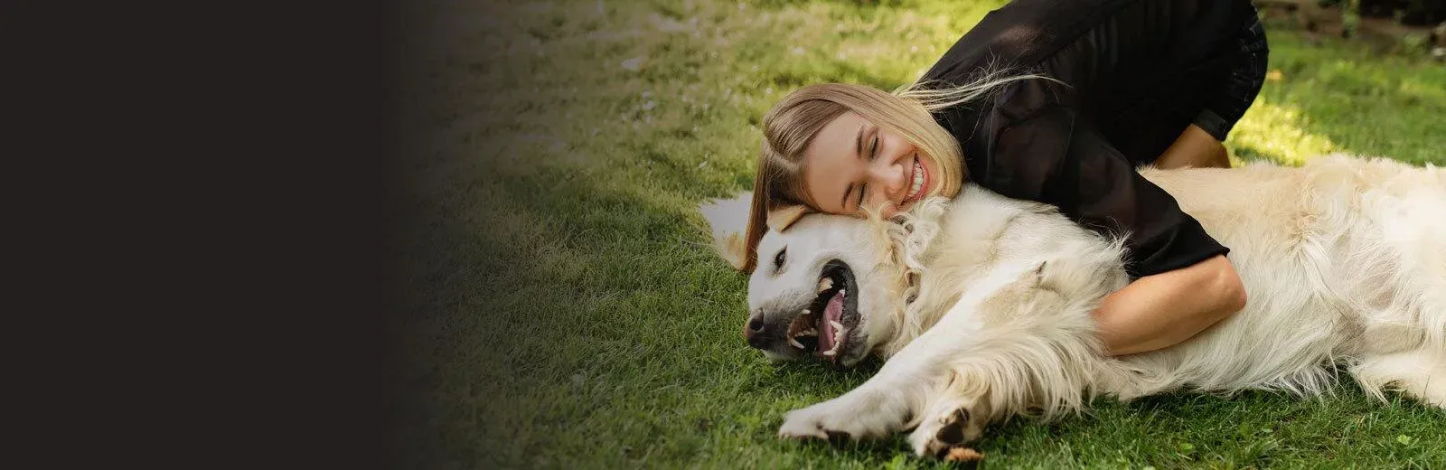 woman playing with dog outside